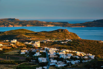 High angle view of townscape by sea against sky