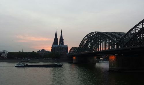 Bridge over river with city in background