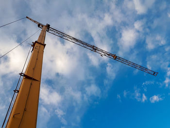 Low angle view of crane against sky