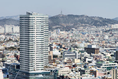 High angle view of buildings in city against clear sky