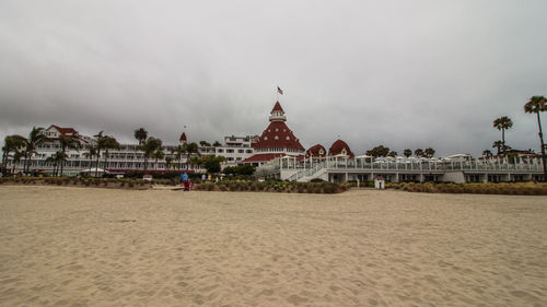 Panoramic view of beach against buildings in city