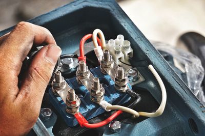 Close-up of man repairing electrical equipment