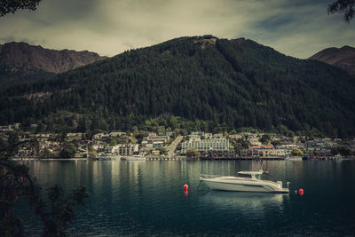 Scenic view of lake by mountains against sky