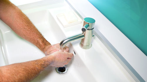 High angle view of hands in bathroom