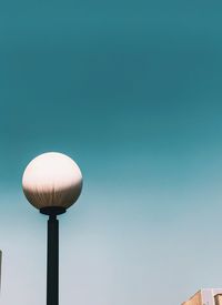 Low angle view of street light against clear blue sky