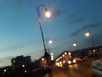 Close-up of illuminated street light in city at night