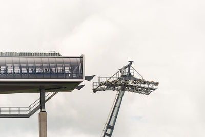 Low angle view of crane against sky