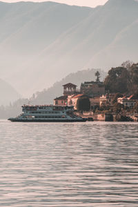 Scenic view of sea by buildings against sky