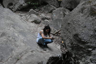 Woman sitting on rock