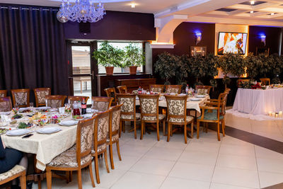 Empty chairs and tables in restaurant