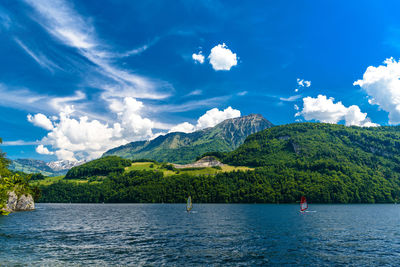 Scenic view of sea and mountains against sky