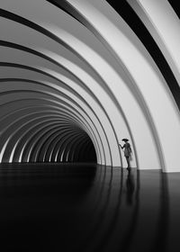 Full length of woman standing in tunnel