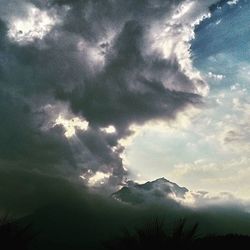 Scenic view of mountains against cloudy sky