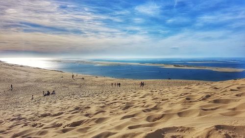 View of beach against cloudy sky