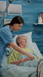 Nurse taking care of patient in hospital