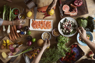 Cropped image of hands preparing food on table