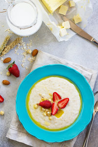Healthy breakfast. porridge of oatmeal with nuts, milk and fresh strawberries. 
