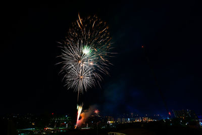 Low angle view of firework display at night