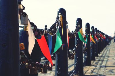 Panoramic shot of padlocks on railing against sky