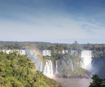 Scenic view of waterfall against sky