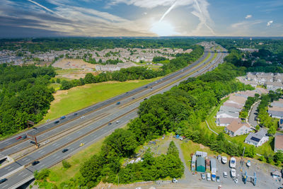 High angle view of road amidst trees against sky