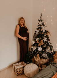 Portrait of woman with christmas tree