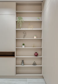 Wardrobe and shelves with decor in the room in a modern style