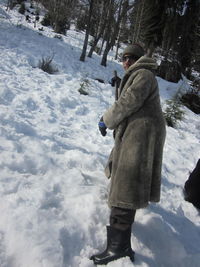 Man standing on snow covered forest