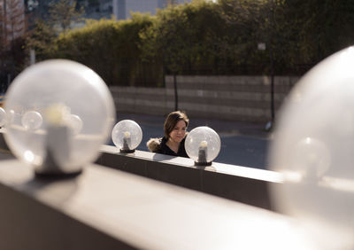 Woman by lighting equipment on road