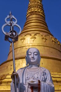 Low angle view of statue against temple building