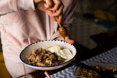 Midsection of person holding food on table