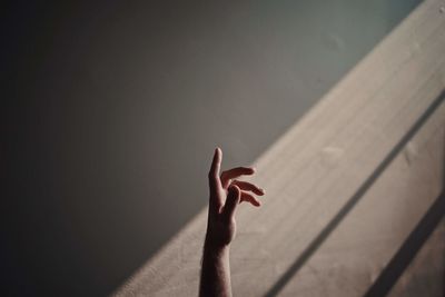 Shadow of person hand on wall