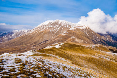 Scenic view of snowcapped mountains against sky