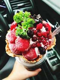 Cropped hand of person holding food