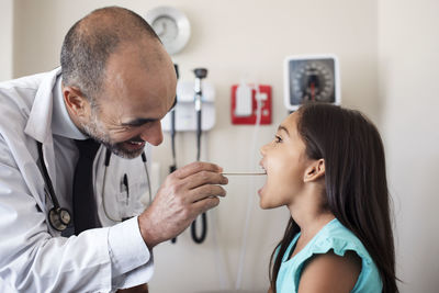Doctor checking girl in medical examination room