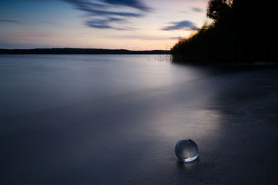 Scenic view of lake against sky at sunset