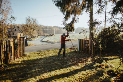 Full length of man raking at yard