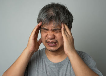 Portrait of man wearing mask against white background