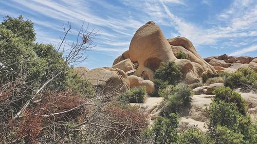 View of rock formation against cloudy sky