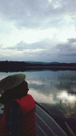 Scenic view of calm lake against cloudy sky