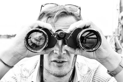 Close-up of tourist using binoculars