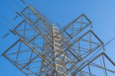 High tension towers against light.