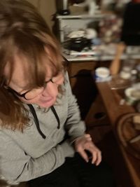 Rear view of girl sitting at home