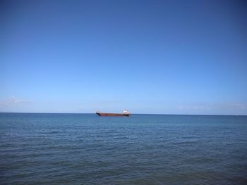 Scenic view of sea against blue sky