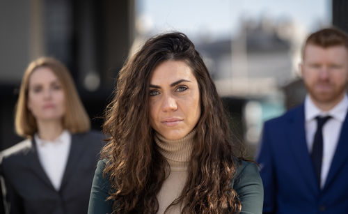 Portrait of smiling friends standing outdoors