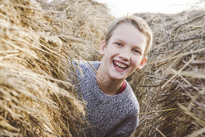 Portrait of smiling young woman in field