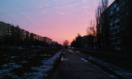 View of city street during sunset