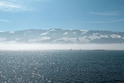 Scenic view of lake and mountains against sky