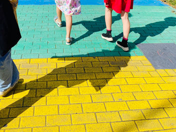 Low section of women walking on street