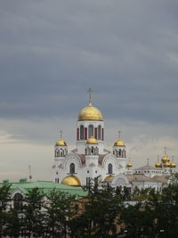 View of buildings against cloudy sky